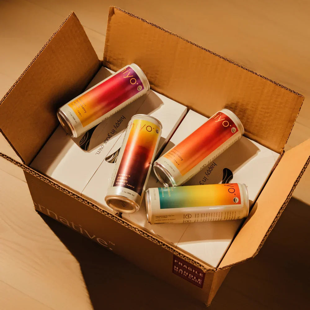Four colorful cans in a cardboard box with 'Native' branding.