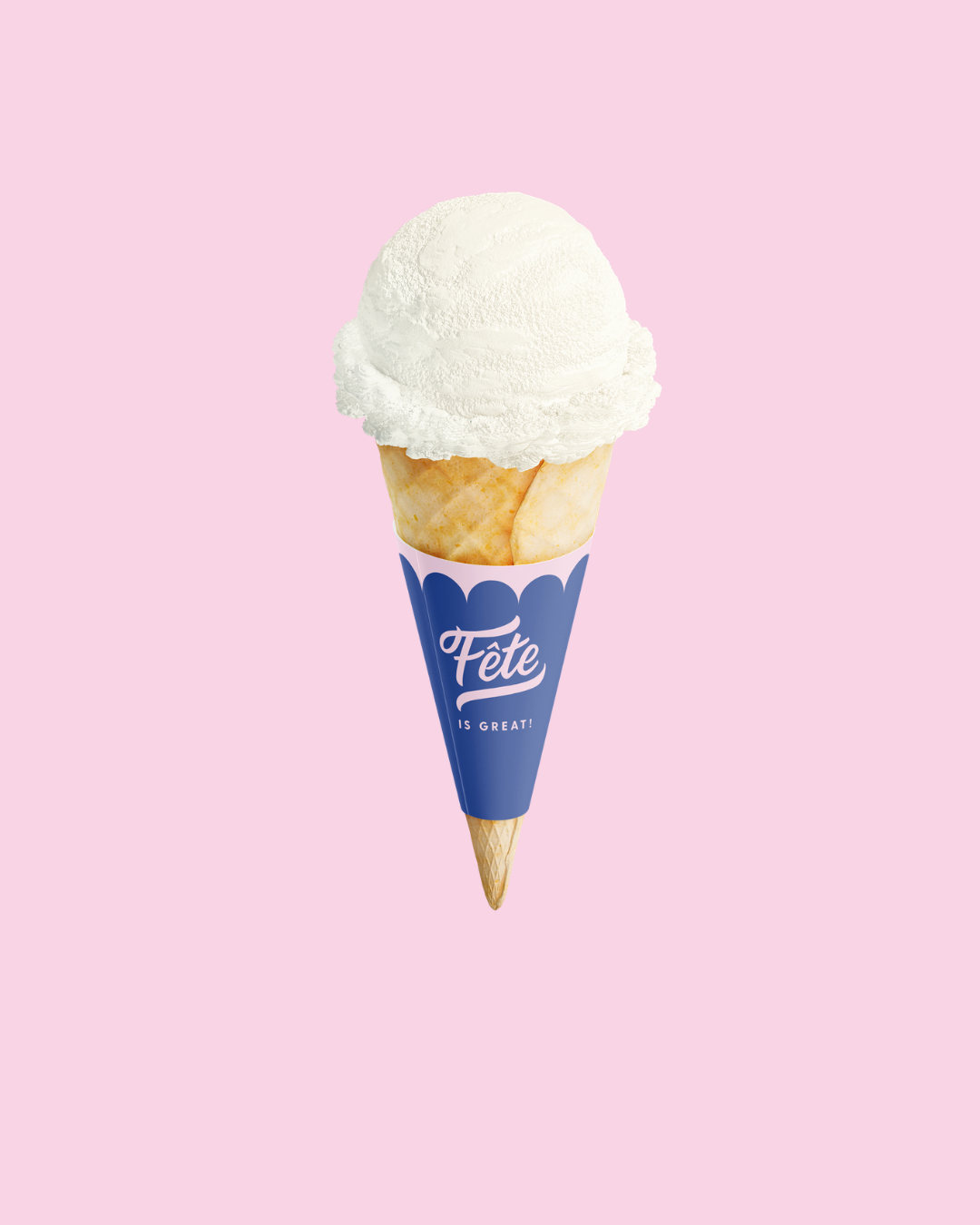 A single scoop of white ice cream in a waffle cone with a blue cone sleeve printed with the brand name 'Fete' and the phrase 'IS GREAT!', centered on a solid light pink background.
